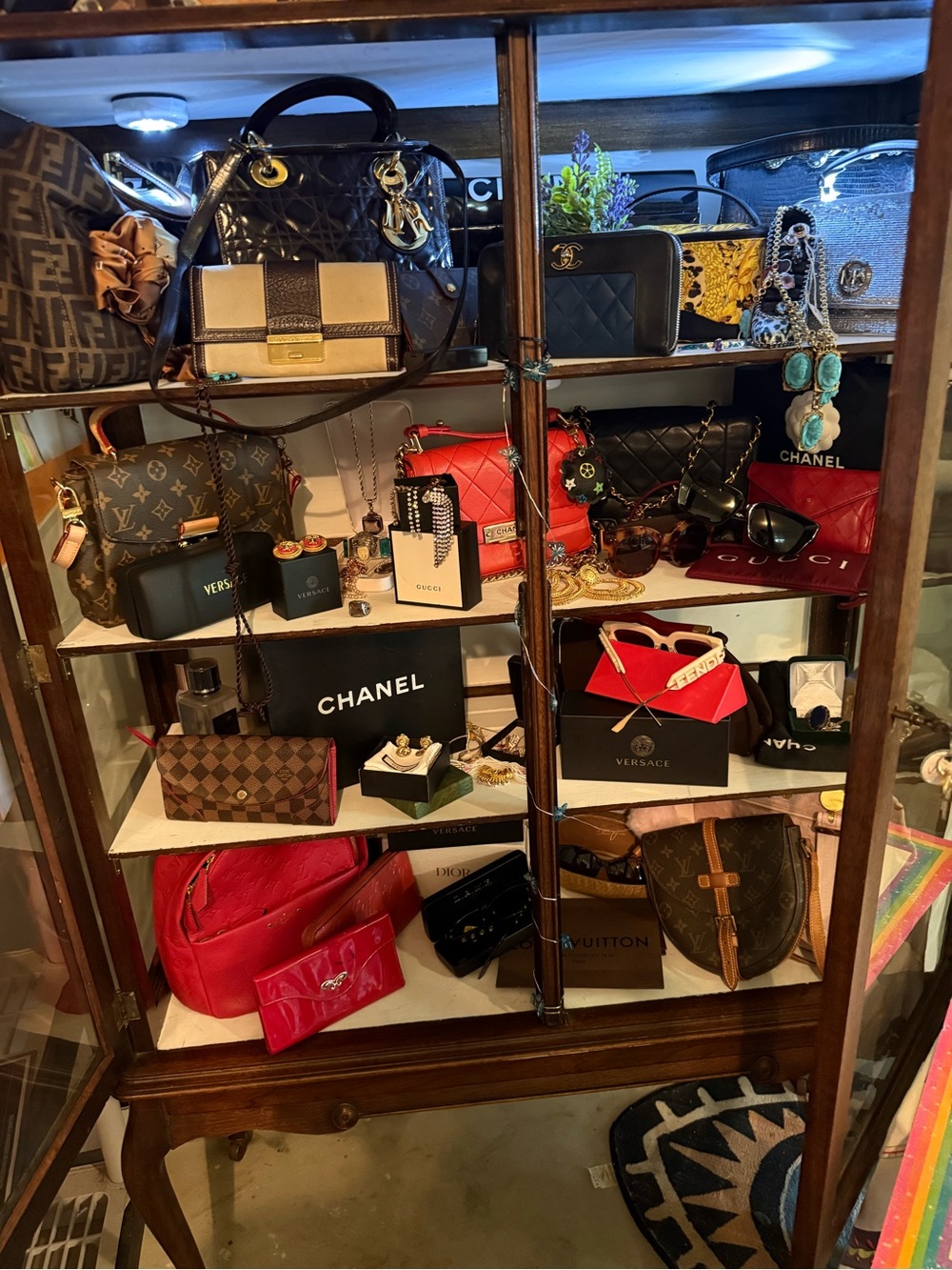 Shelf of Assorted Designer Handbags and Accessories - Black, Red, Brown